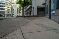 a street view with steps and trees with building in the background in front of it