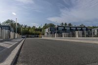 a highway with a parking meter at the end of it and several buildings in the background