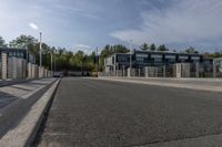 a highway with a parking meter at the end of it and several buildings in the background