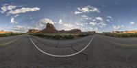 a 3d photo of a wide open desert road showing the desert mountains and the empty side of the road