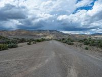 Straight Road in Utah: Cloud-Filled Sky and Dusty Street