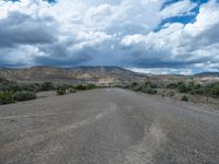 Straight Road in Utah: Cloud-Filled Sky and Dusty Street