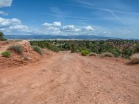 Straight Road in Utah: Clouds, Dirt, and Gravel Streets