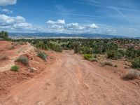 Straight Road in Utah: Clouds, Dirt, and Gravel Streets