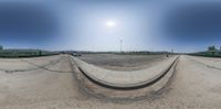 the view from inside a fish eye lens on two trains in a rail yard next to a street