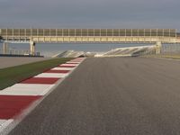 A Straight View: Asphalt Road and Clear Skies