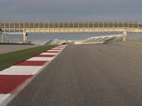 A Straight View: Asphalt Road and Clear Skies