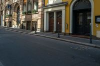 there is a yellow building in the background and a black door on the right side