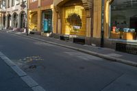 the city street is full of street signs on each side of it with a bench sitting in the middle