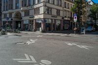 a bike lane in a town with buildings and bicycles parked on the sidewalks and buildings