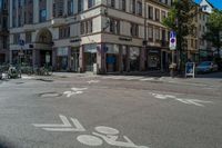 a bike lane in a town with buildings and bicycles parked on the sidewalks and buildings