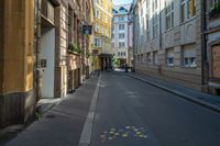 a view down a city street with many small dots painted on it and buildings lining the walkway