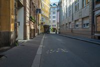 a view down a city street with many small dots painted on it and buildings lining the walkway