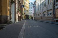 a view down a city street with many small dots painted on it and buildings lining the walkway