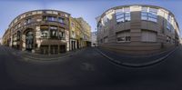 a view of an upside down building and street from the other side of a 360 - lens shot