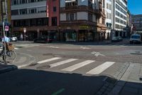 a bike parked at a red light in front of buildings in a european city intersection