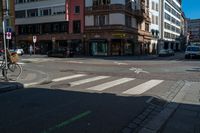 a bike parked at a red light in front of buildings in a european city intersection