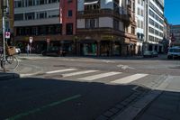 a bike parked at a red light in front of buildings in a european city intersection