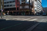 a bike parked at a red light in front of buildings in a european city intersection