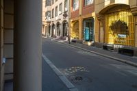 a street with buildings and a crosswalk sign painted on it in front of an empty building