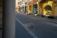 a street with buildings and a crosswalk sign painted on it in front of an empty building