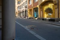 a street with buildings and a crosswalk sign painted on it in front of an empty building