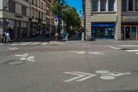 an empty bicycle path is marked with markings in front of buildings on the street in the city