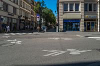 an empty bicycle path is marked with markings in front of buildings on the street in the city