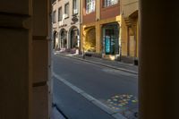 a street that has some very small yellow poles in it and some buildings in the background