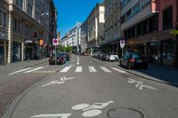 a street with bicycle lanes and street signs on the side of it and some buildings