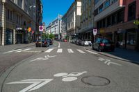 a street with bicycle lanes and street signs on the side of it and some buildings