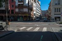 a bicycle is leaning up to a parking spot on a city street corner, with a traffic light on a pole