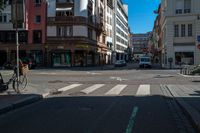 a bicycle is leaning up to a parking spot on a city street corner, with a traffic light on a pole