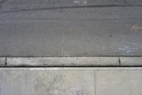 the sidewalk has graffiti painted on it and writing in blue ink next to an outside fire hydrant