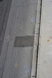 the sidewalk has graffiti painted on it and writing in blue ink next to an outside fire hydrant