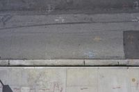 the sidewalk has graffiti painted on it and writing in blue ink next to an outside fire hydrant