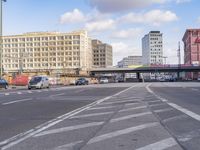 a street with cars and people passing through the center of it is the same intersection