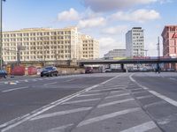 a street with cars and people passing through the center of it is the same intersection