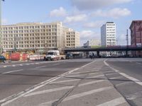 a street with cars and people passing through the center of it is the same intersection