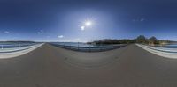 this is an 360 - turn of the street bridge with a blue sky and clouds overhead