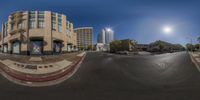 an image of a fish eye view of a street corner with buildings and a cityscape