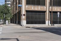 this is a street corner near an old building with an american flag and a traffic light in front of it