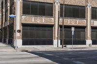 this is a street corner near an old building with an american flag and a traffic light in front of it