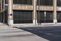 this is a street corner near an old building with an american flag and a traffic light in front of it