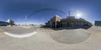 360 - view of street intersection and light pole with traffic passing in front of building