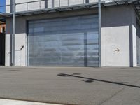 a street light and sign next to a large garage door in front of a garage