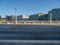 street intersection on the waterfront with buildings on both sides and empty lot in the middle