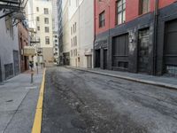 an empty street that has a parking meter on it near some buildings in front of the building