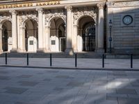 a street scene with the shadow of the person walking along the sidewalk of the building