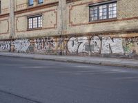 an image of a street scene with two motorcycles and some graffiti on the wall near the street